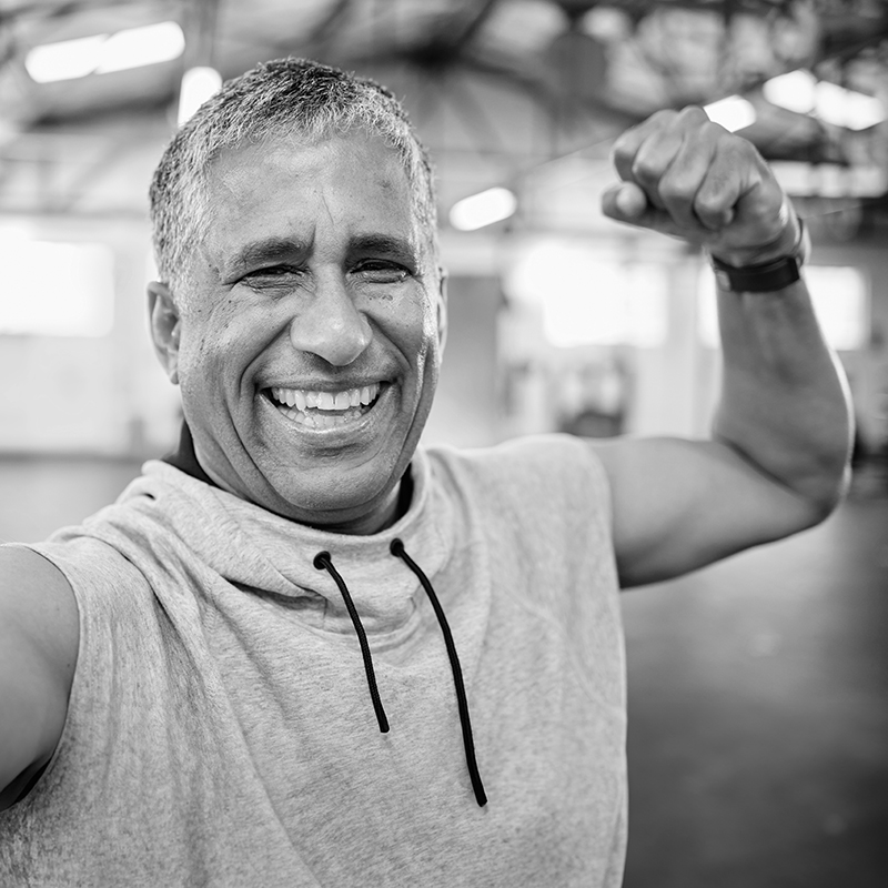 Fit older man flexing biceps